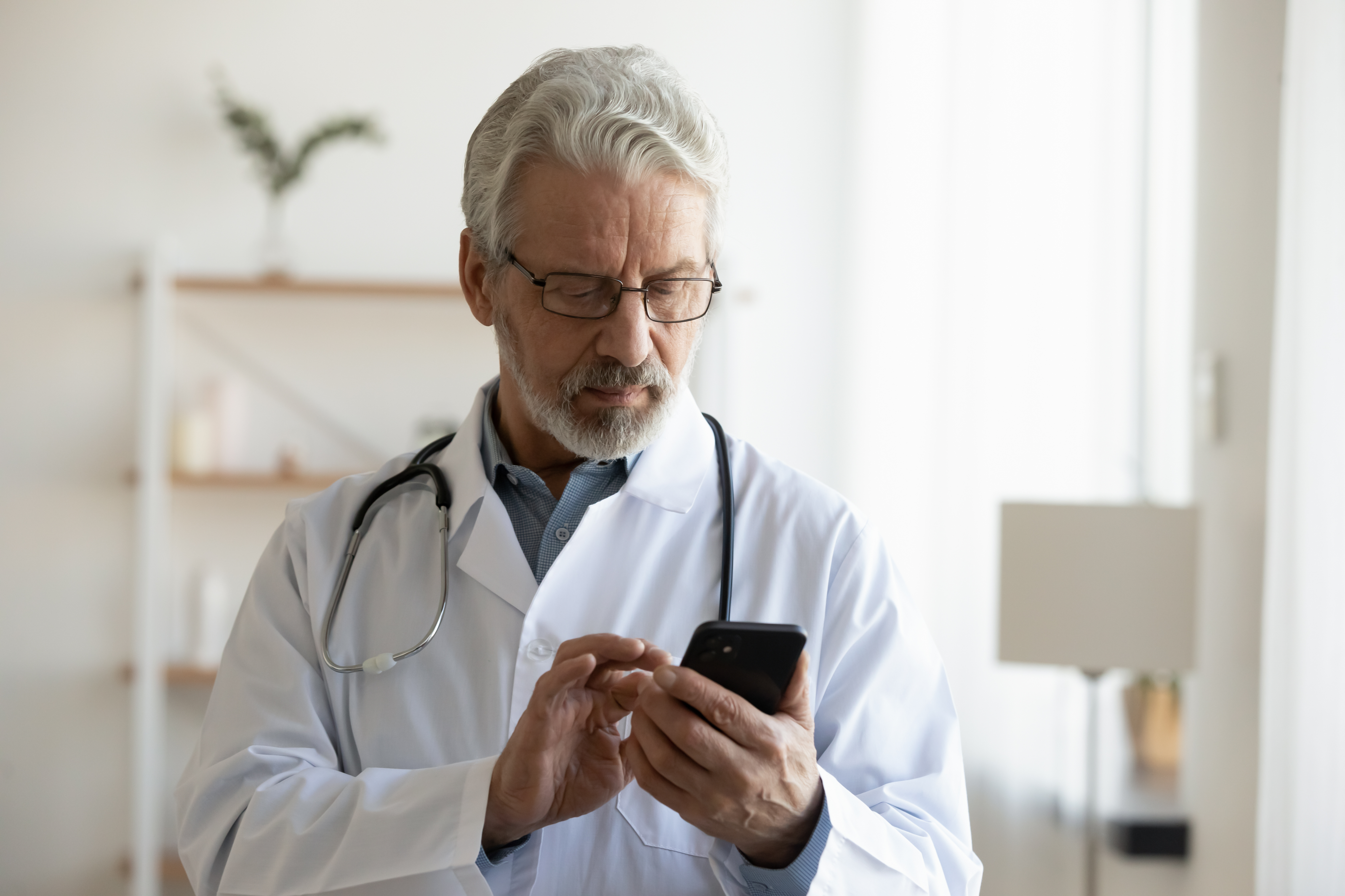 Doctor looking at phone